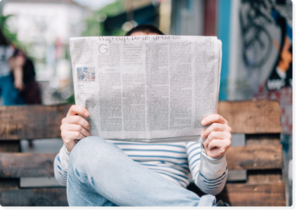 person holding newspaper