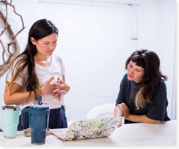 two women viewing laptop